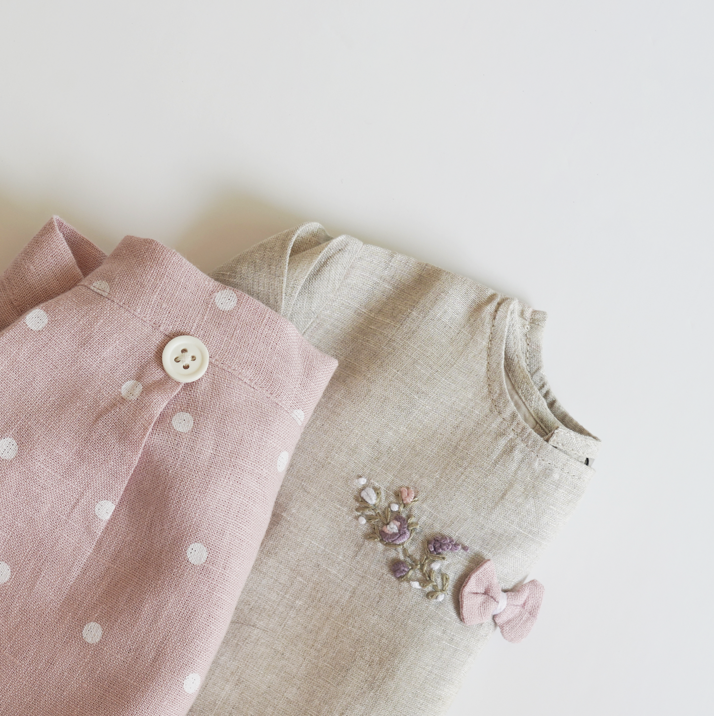 Pink hand embroidered polka dot shorts and top set in pure linen fabric, featuring floral embroidery and matching bow for children’s wear.