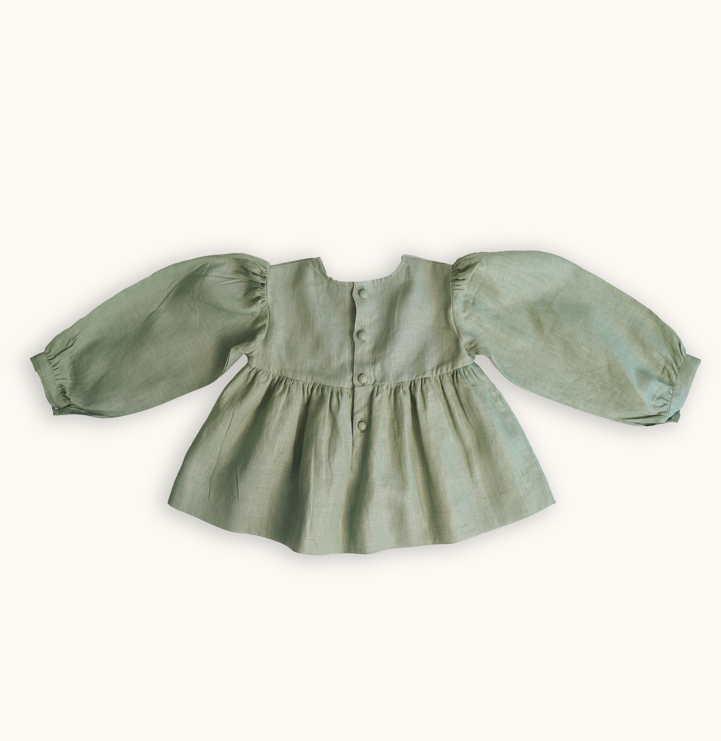 Baby girls' linen floral embroidered top, featuring hand-embroidered flowers, perfect for stylish and comfortable baby wear. Ideal for baby fashion and organic luxury clothing collections