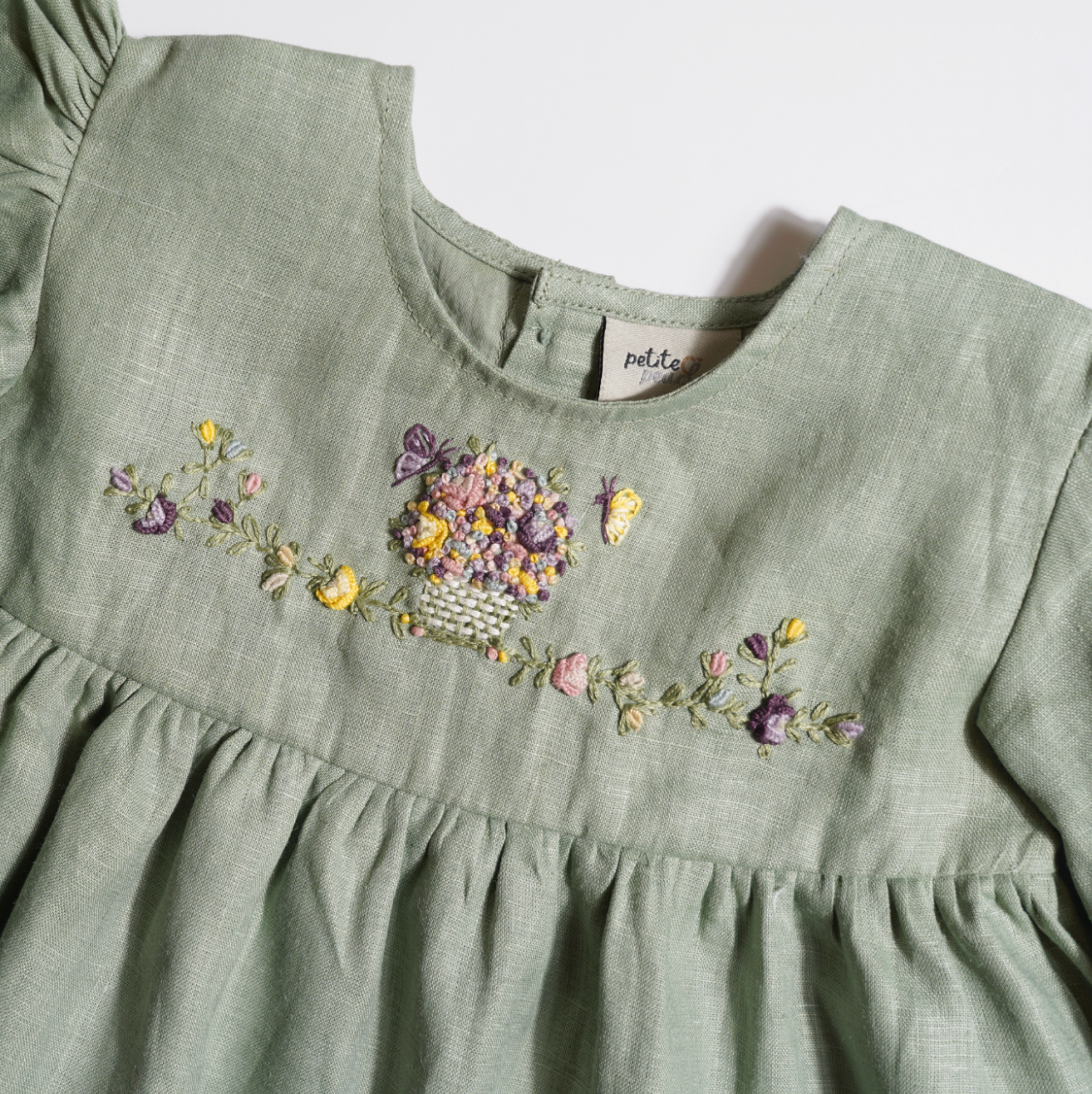 Baby girls' linen floral embroidered top, featuring hand-embroidered flowers, perfect for stylish and comfortable baby wear. Ideal for baby fashion and organic luxury clothing collections