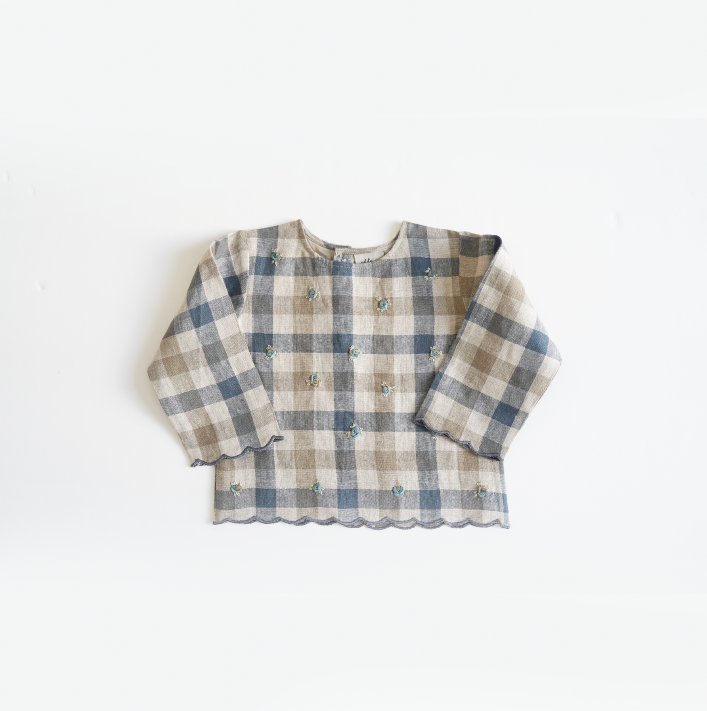 Chequered hand-embroidered top in pure linen with comfortable cotton lining and scalloped hem, perfect for stylish and cozy baby wear. Ideal for baby girls' designer wear and comfortable luxury clothing collections.